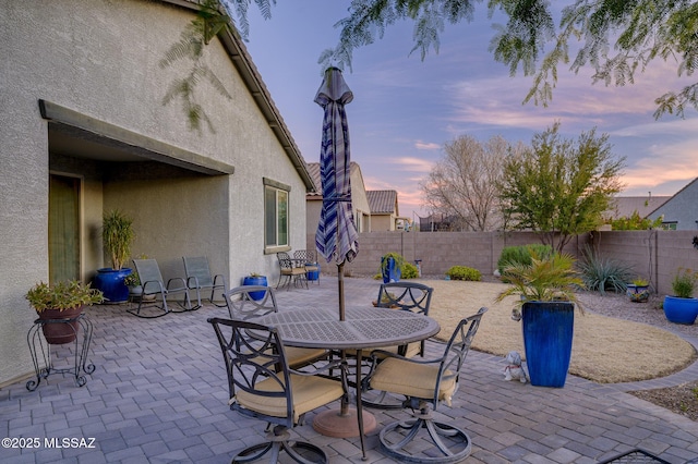 view of patio terrace at dusk