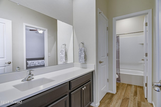 full bathroom featuring vanity, wood-type flooring, shower / bath combo, and toilet