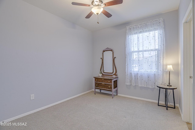 spare room featuring ceiling fan and light colored carpet