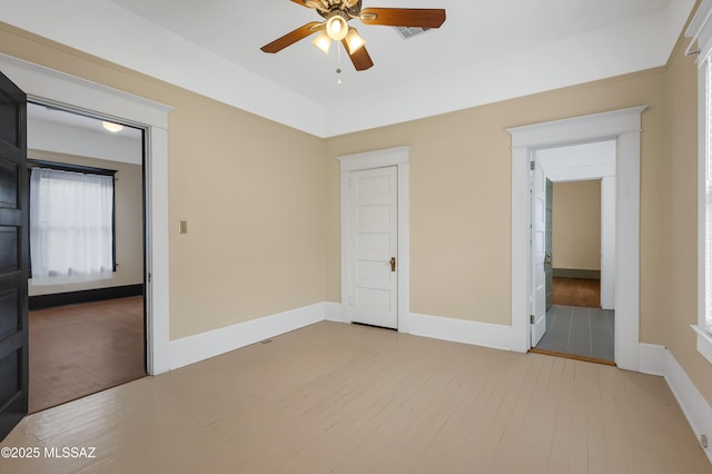 unfurnished bedroom featuring ceiling fan, light hardwood / wood-style floors, and a closet