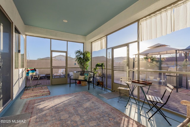 sunroom featuring a mountain view