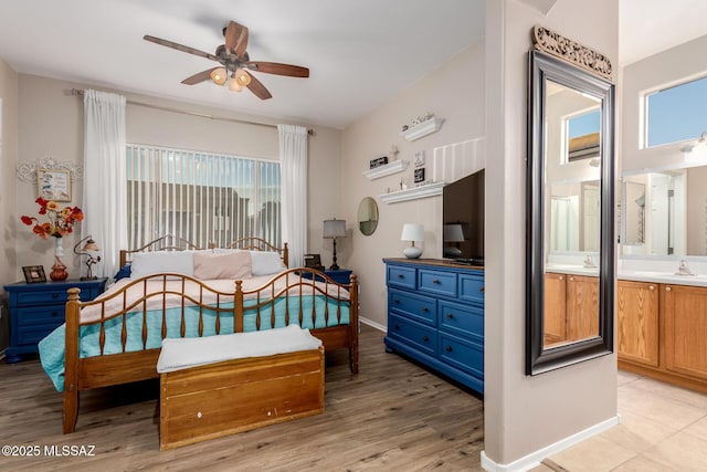 bedroom featuring sink and light hardwood / wood-style floors