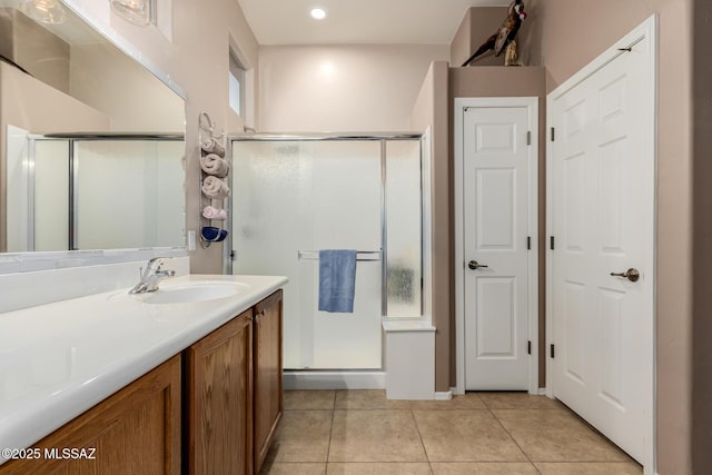 bathroom featuring vanity, an enclosed shower, and tile patterned flooring