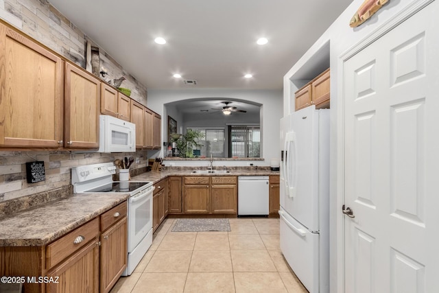 kitchen with sink, white appliances, light tile patterned floors, ceiling fan, and decorative backsplash