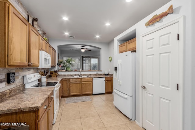 kitchen with sink, white appliances, light tile patterned floors, ceiling fan, and decorative backsplash