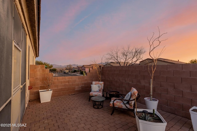 view of patio terrace at dusk