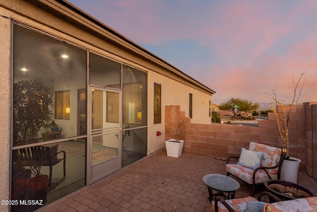 view of patio terrace at dusk