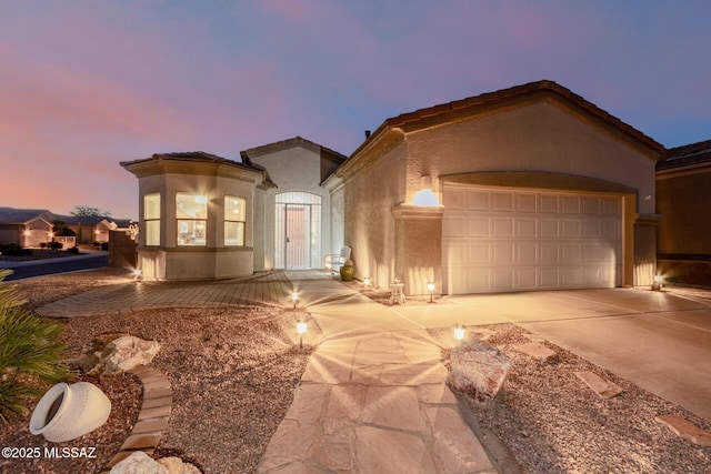 mediterranean / spanish home featuring a garage