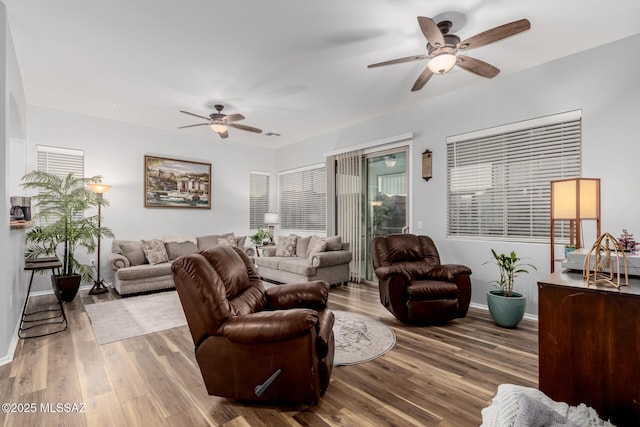 living room featuring hardwood / wood-style flooring and ceiling fan