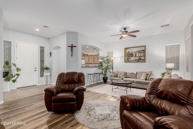 living room featuring ceiling fan and wood-type flooring