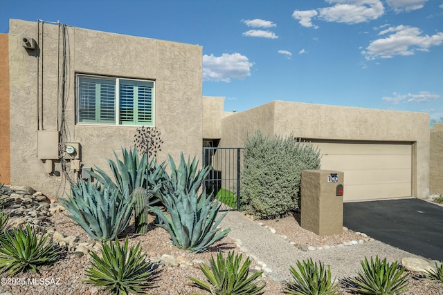 pueblo-style home featuring a garage