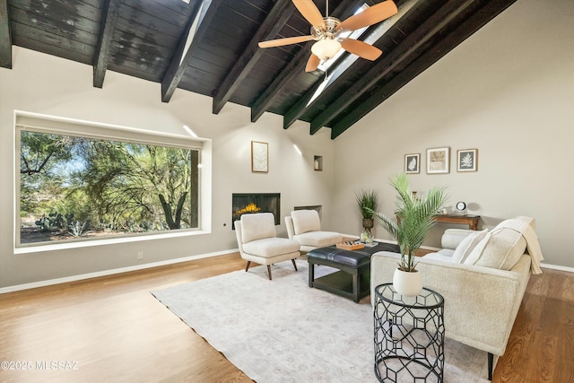 living room featuring hardwood / wood-style flooring, ceiling fan, wood ceiling, and beam ceiling