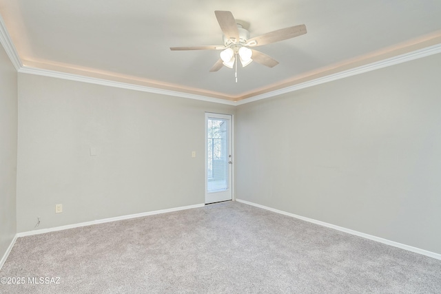 carpeted spare room featuring crown molding and ceiling fan