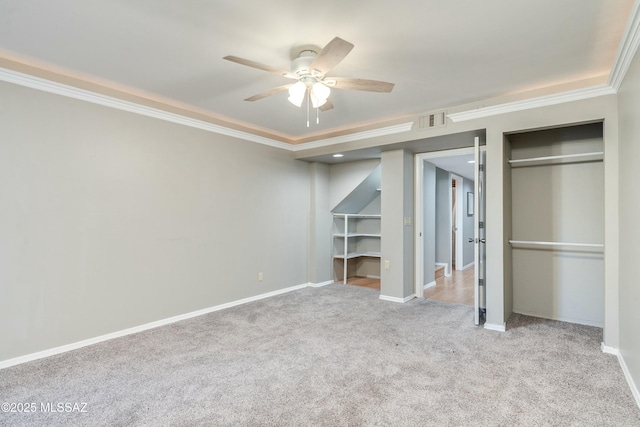 unfurnished bedroom featuring ornamental molding, light carpet, and ceiling fan