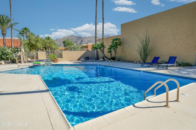 view of pool featuring a mountain view and a patio