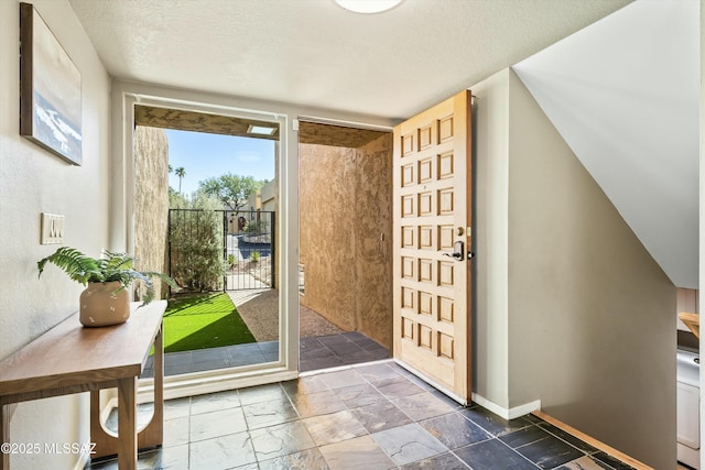 doorway featuring a textured ceiling