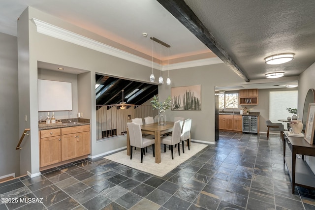 dining room with ornamental molding, indoor wet bar, wine cooler, and a textured ceiling