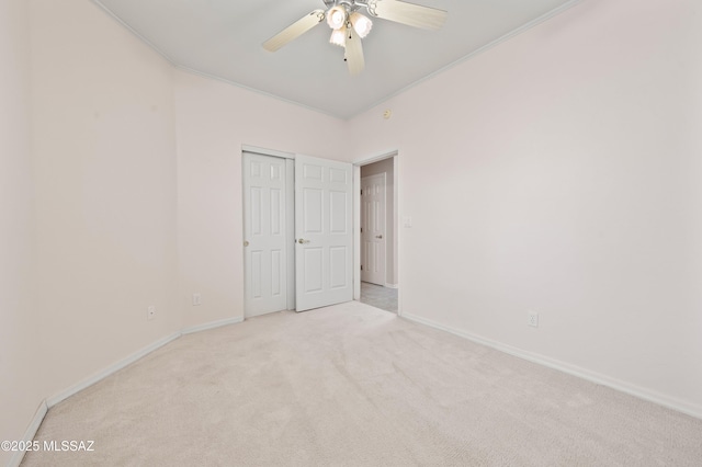 unfurnished bedroom with carpet floors, ornamental molding, a closet, and baseboards