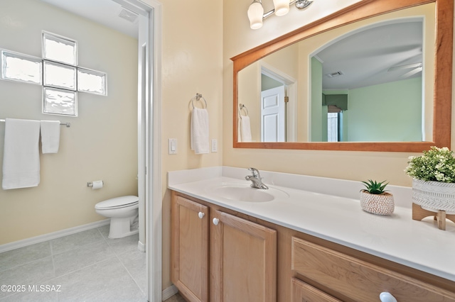 bathroom featuring baseboards, visible vents, toilet, tile patterned floors, and vanity