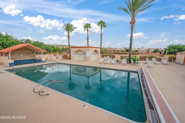 pool featuring a patio and fence