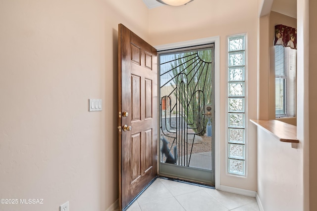 entrance foyer featuring light tile patterned flooring and baseboards