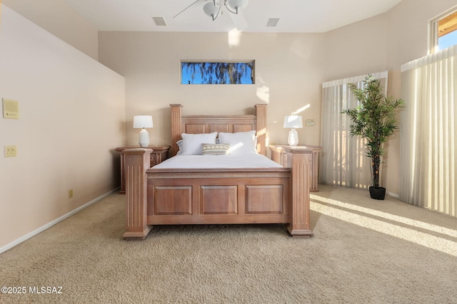 bedroom featuring light carpet, visible vents, and baseboards