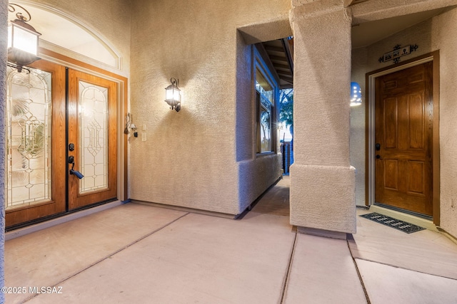 entrance to property with french doors and stucco siding