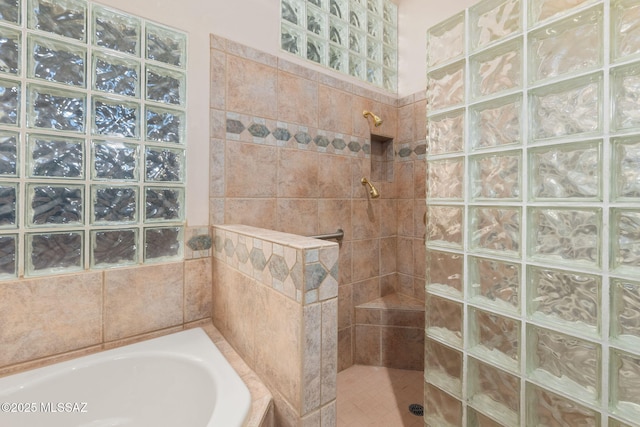 bathroom featuring a bath and a walk in shower