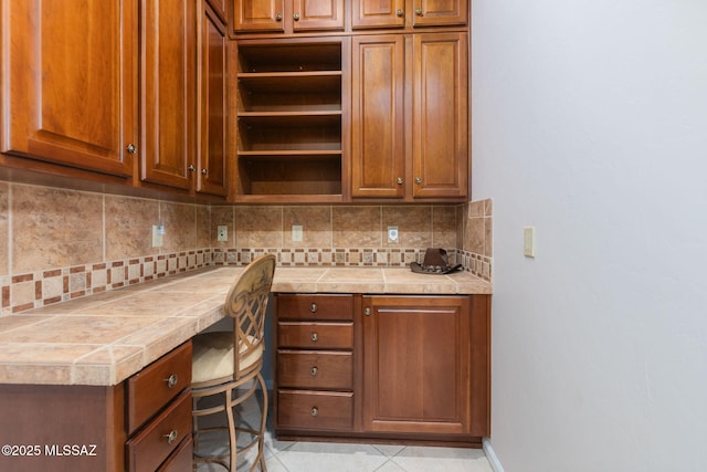 unfurnished office featuring light tile patterned floors and baseboards