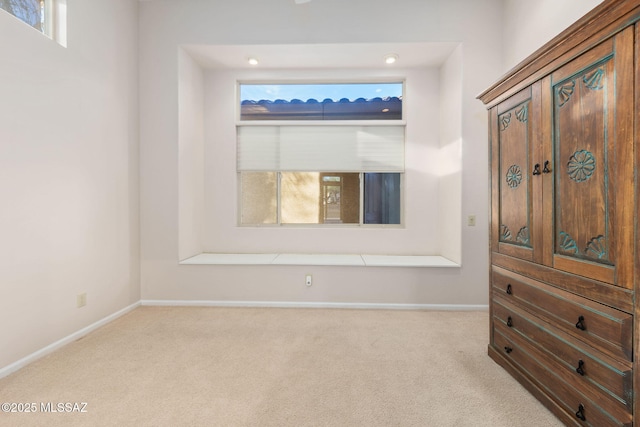 spare room featuring baseboards and carpet floors