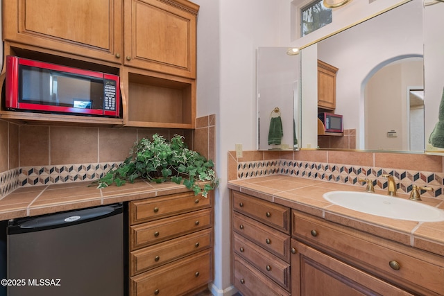 bathroom with decorative backsplash and vanity