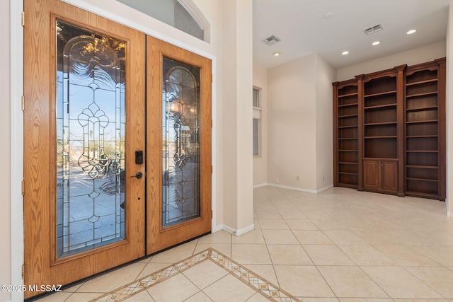 tiled foyer featuring recessed lighting, visible vents, baseboards, and french doors