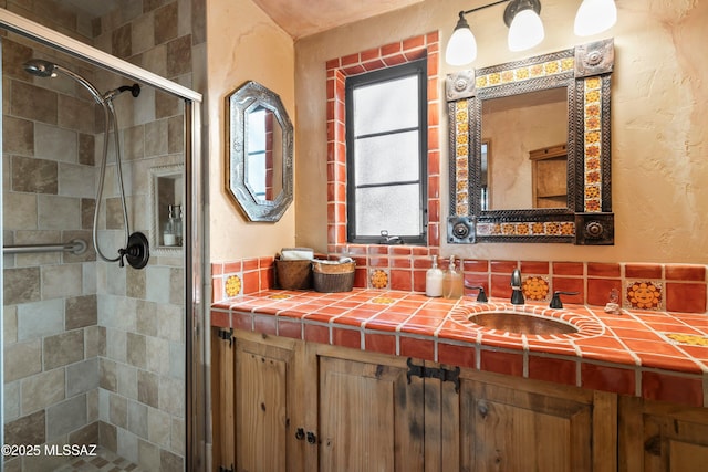 bathroom with vanity and a shower with shower door