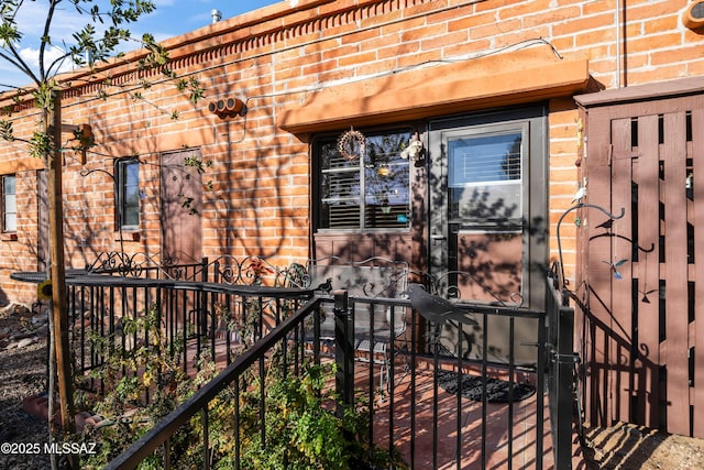 doorway to property featuring brick siding