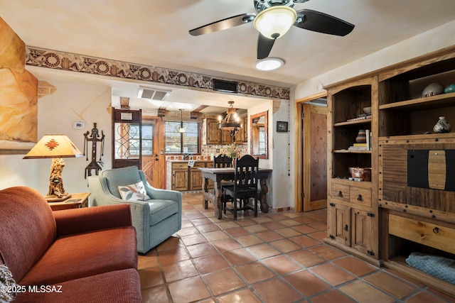 living room featuring tile patterned floors and ceiling fan