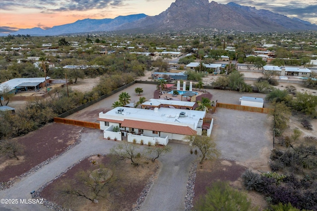 aerial view at dusk featuring a mountain view