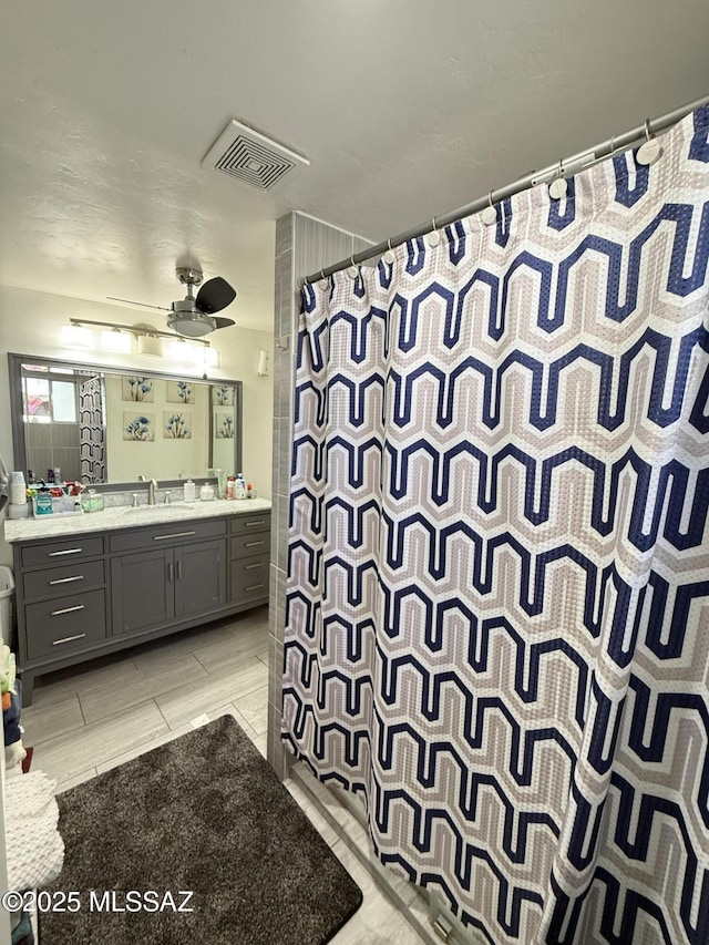 bathroom featuring vanity and ceiling fan