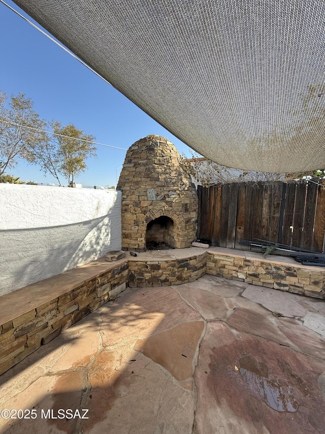 view of patio / terrace featuring an outdoor stone fireplace