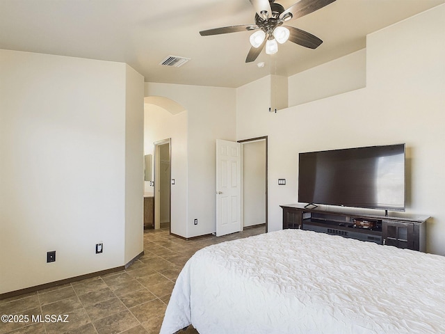 bedroom with ceiling fan and ensuite bath