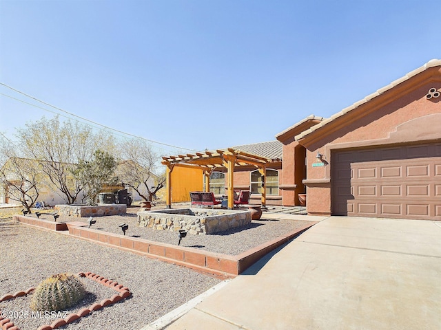 view of front of house with a garage and a pergola