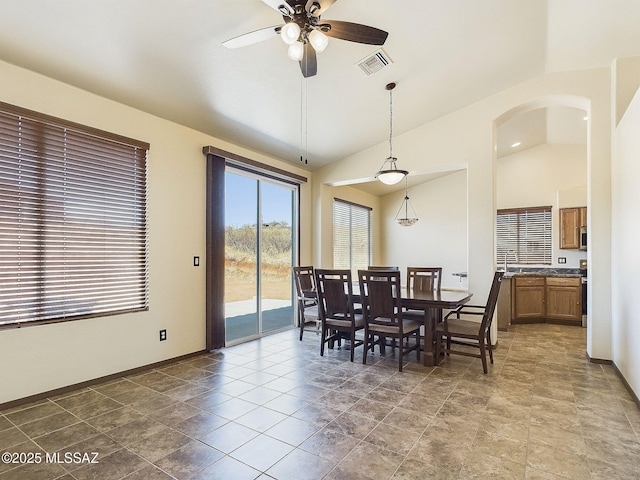 dining space with vaulted ceiling and ceiling fan