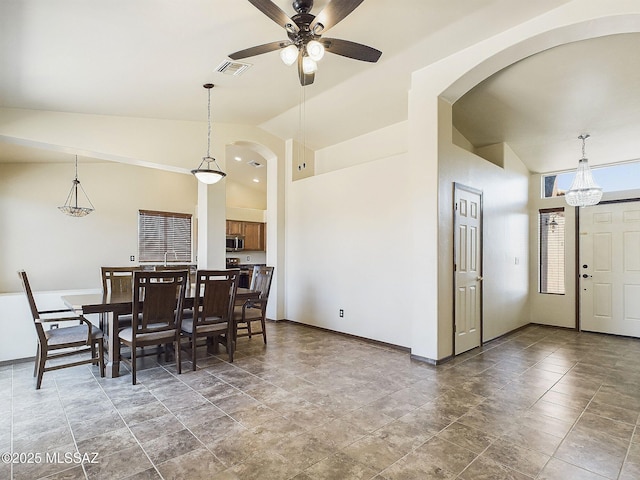 dining space with high vaulted ceiling and ceiling fan