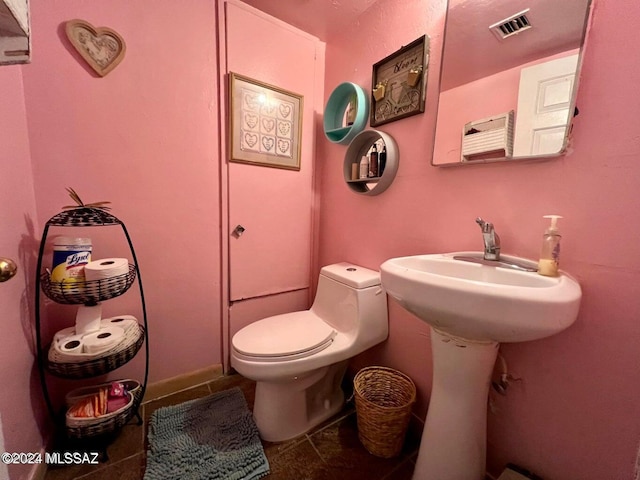 bathroom with tile patterned floors and toilet