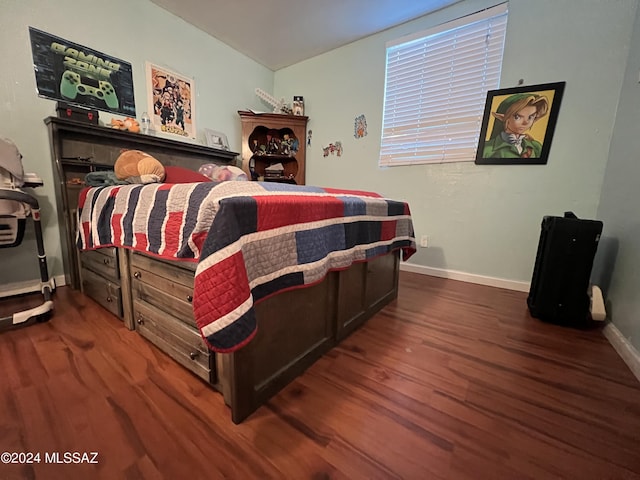 bedroom with dark hardwood / wood-style flooring