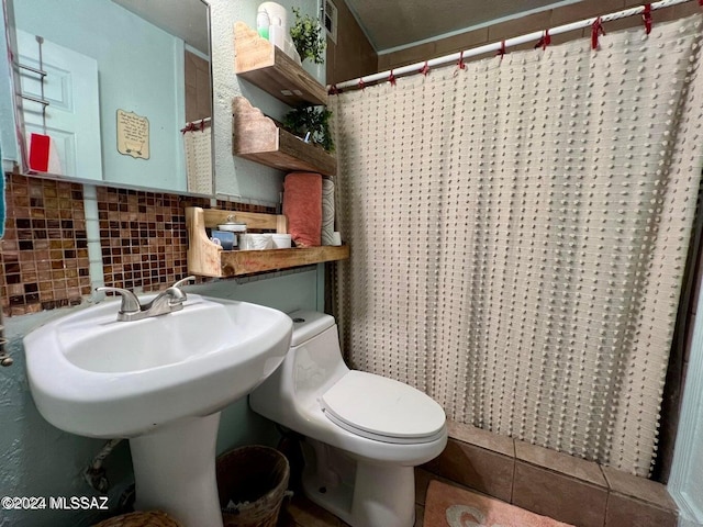 bathroom with tile patterned flooring, tile walls, curtained shower, and toilet