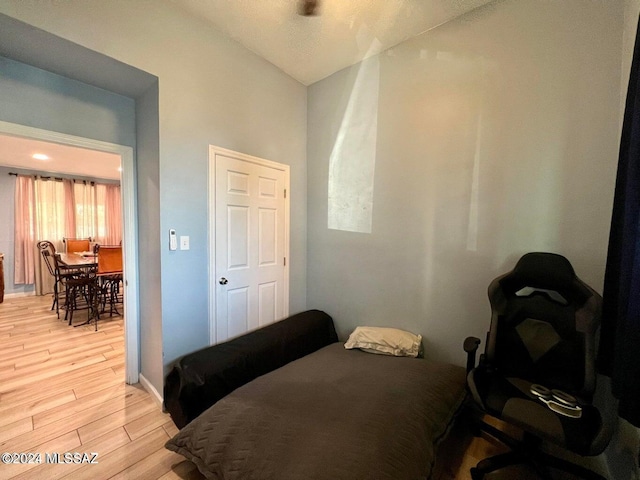 bedroom featuring vaulted ceiling and light wood-type flooring