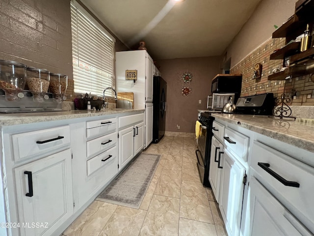 kitchen with white cabinetry, backsplash, sink, and black appliances