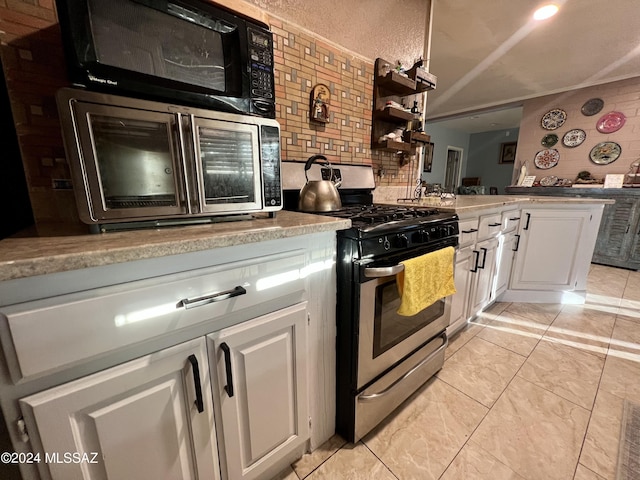 kitchen featuring white cabinetry and appliances with stainless steel finishes