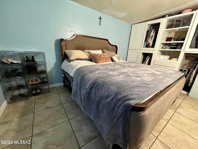 tiled bedroom featuring vaulted ceiling