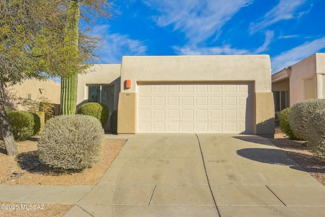 pueblo-style house featuring a garage